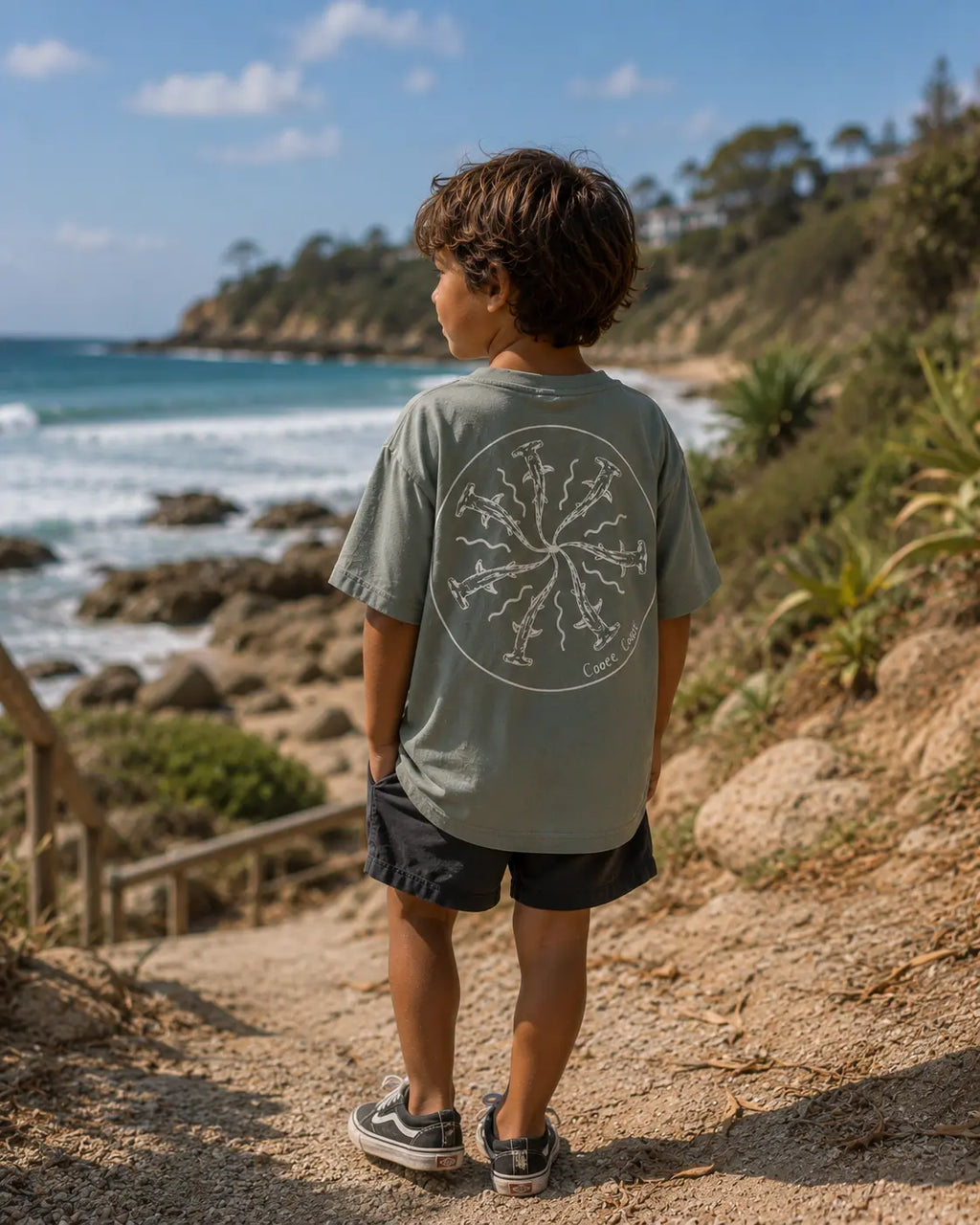 Back view of boy wearing Cooee Coast, coastal flow tee Salty Sage Shark Print
