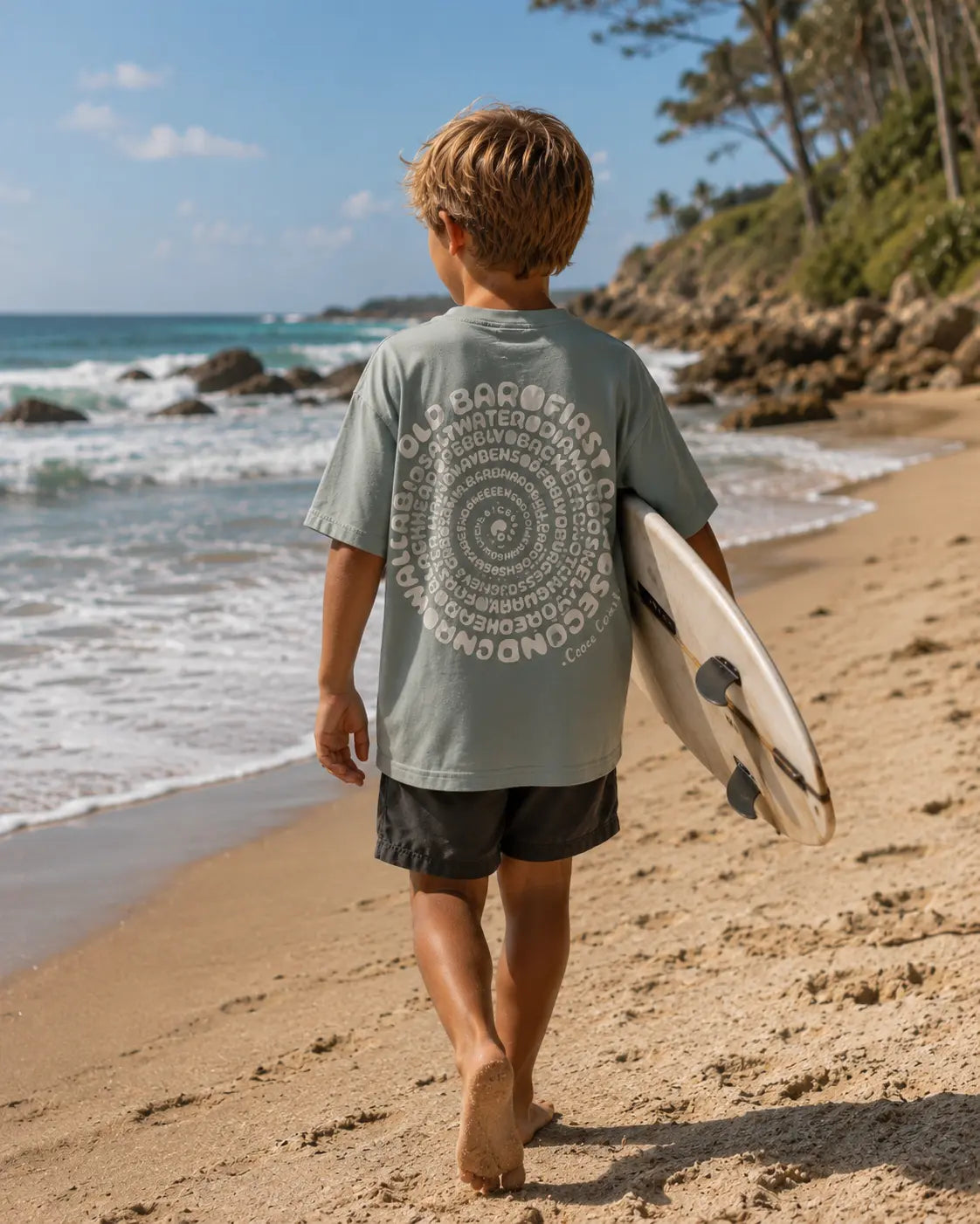 Back view of boy wearing Cooee Coast, coastal flow tee Salty Sage Spiral Print