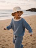 Child wearing Cooee Coast Cord Bucket Hat featuring soft cord texture and coastal style.
