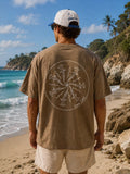 Back view of man wearing Cooee Coast Men’s Tee featuring Hammerhead Swirl back print On a beach 