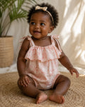 Baby wearing Cooee Coast Mia Romper featuring coastal print and adjustable tie straps