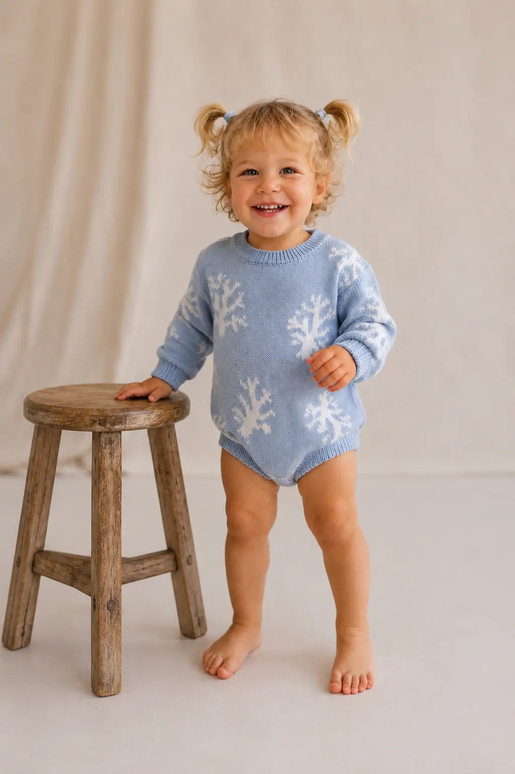 Baby wearing Cooee Coast Reef Romper in ocean blue with reef-inspired knit pattern
