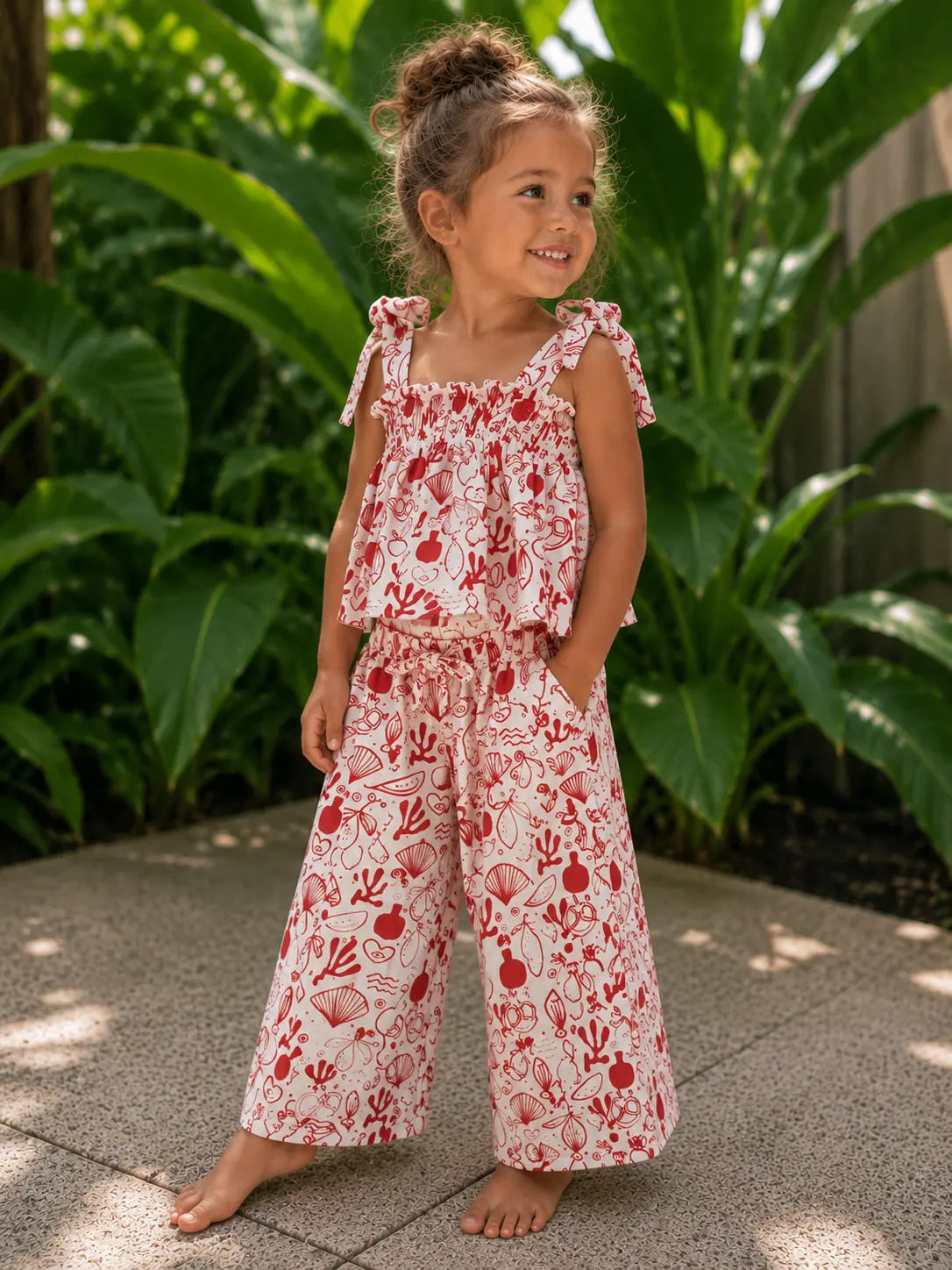 Girl wearing Cooee Coast Sunset Two Piece Set featuring relaxed fit and adjustable details