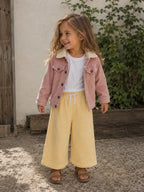 Child wearing Cooee Coast pink Teddy-Lined Corduroy Jacket featuring soft cord texture and relaxed Fit