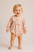 Baby wearing Cooee Coast Willow Romper in linen blend with elastic frill sleeves and relaxed fit